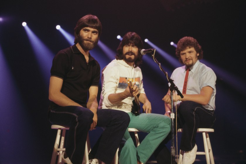 Alabama (Randy Owen, Teddy Gentry and Jeff Cook), U.S. country music band, pose sitting on stools, circa 1980.. (