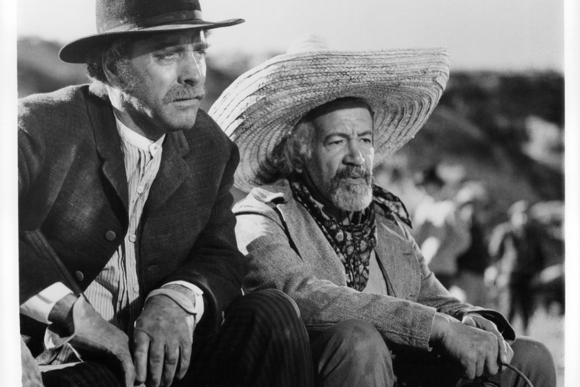 Burt Lancaster and Frank Silvera with hats on, looking out yonder in a scene from the film 'Valdez Is Coming', 1971.