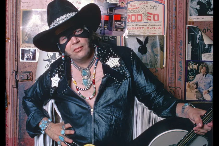 Musician, singer, song writer, entertainer and country music legend, David Allan Coe with guitar dressed as The Mysterious Rhinestone Cowboy for the cover of The New York magazine in August 1975. Photographed waist up at Tootsie's Orchid Lounge, Nashville, Tennessee. Photo is part of the Nashville Music Collection. 