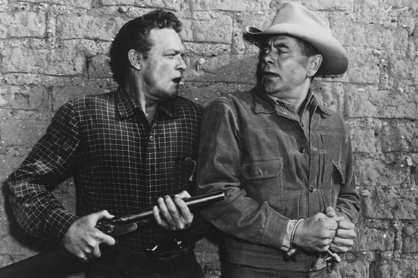 American actor Van Heflin (1910 - 1971, left) as Dan Evans, and Canadian-born American actor Glenn Ford (1916 - 2006) as Ben Wade in '3:10 To Yuma', directed by Delmer Daves, 1957. 