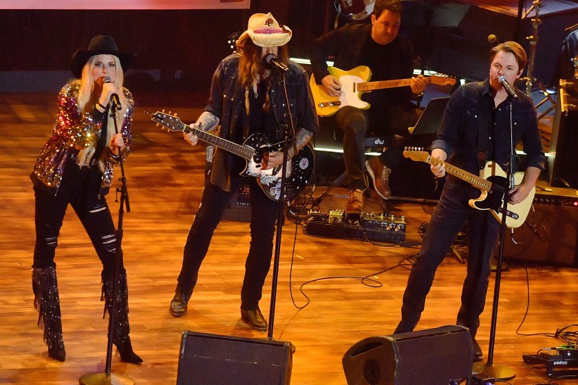 NASHVILLE, TENNESSEE - AUGUST 23: (L-R) FIREROSE, Billy Ray Cyrus, and Travis Denning perform onstage during the 16th Annual Academy of Country Music Honors at Ryman Auditorium on August 23, 2023 in Nashville, Tennessee.