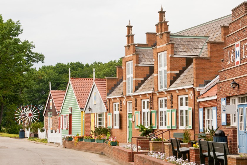 "A row of houses and businesses on Windmill Island in Holland, Michigan. Traditional Dutch culture and architecture along the row of buildings."