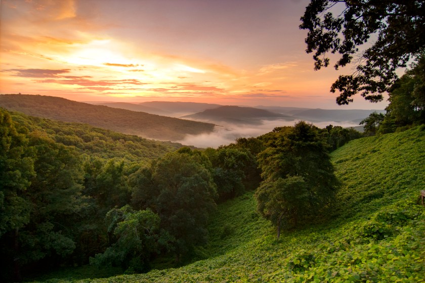 View of a sunrise in the Ozark Mountains, Arkansas. Overlook of foggy mountains in the sun.