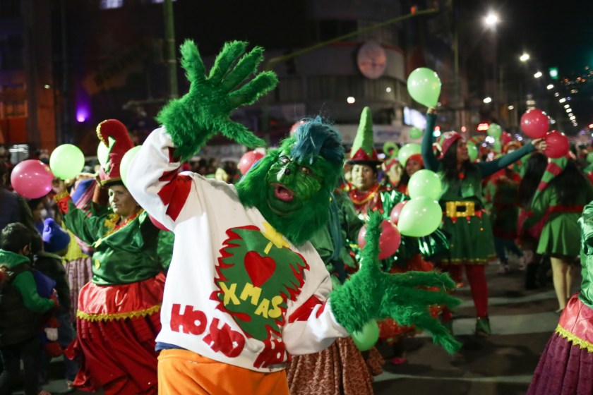 LA PAZ, BOLIVIA - NOVEMBER 25: A man dressed as the Grinch leads a group during the Merchants' Christmas Parade in La Paz, Bolivia on November 25, 2022. Hundreds of merchants held a Christmas parade in the streets of the city of La Paz to kick off the activities for the end of the year festivities, as well as to inaugurate the traditional Christmas fair that is responsible for selling different items with reasons for the Christmas Eve.