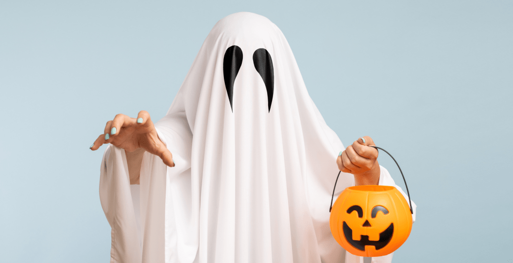 ghost costume with person holding candy bucket