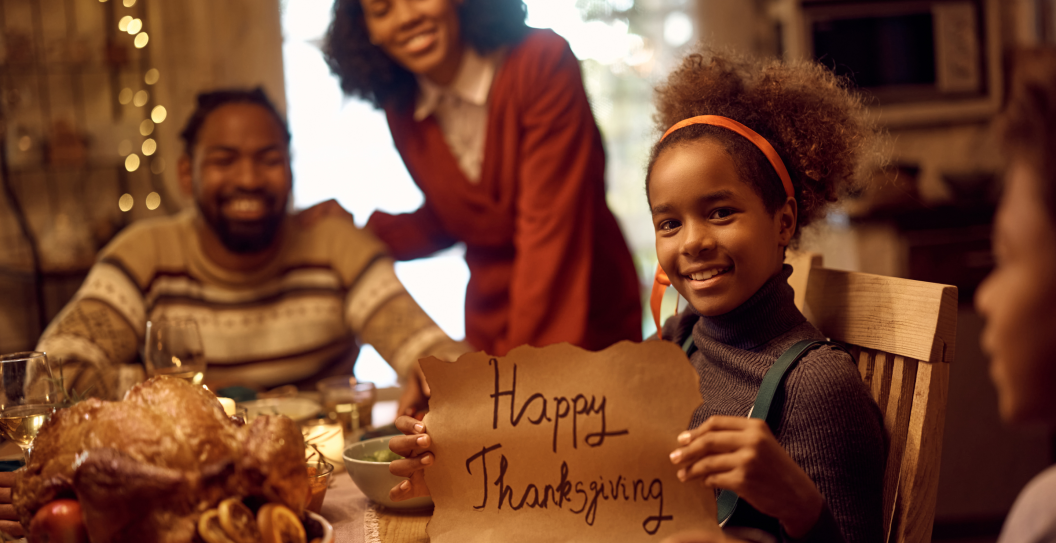 family celebrating Thanksgiving around the table