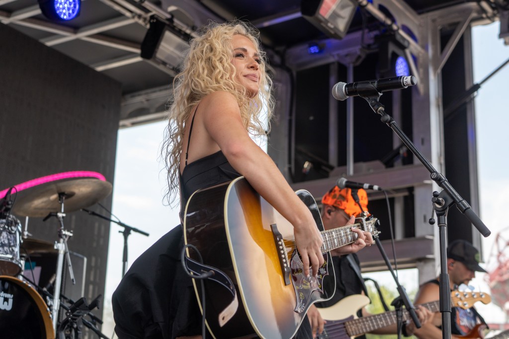 NASHVILLE, TENNESSEE - AUGUST 05: Megan Moroney performs on the iHeart Country Stage during the 2023 Big Machine Music City Grand Prix on August 05, 2023 in Nashville, Tennessee.