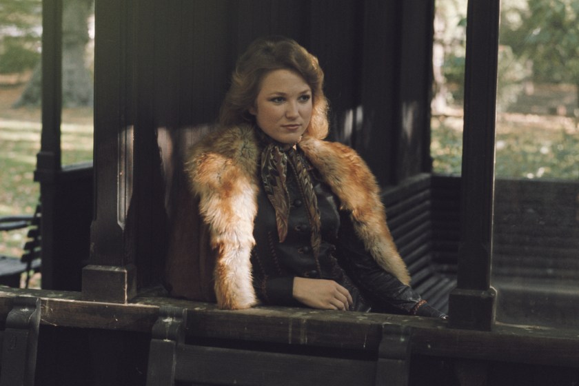 American country music singer-songwriter Tanya Tucker posed sitting on a seat in a London park, 16th October 1975.
