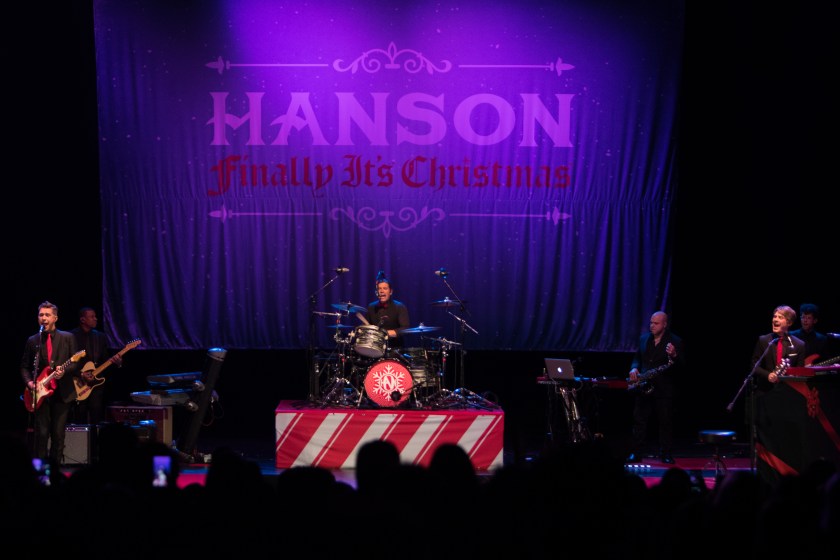 LOS ANGELES, CA - DECEMBER 06: (L-R) Isaac Hanson, Zac Hanson and Taylor Hanson of the band Hanson performs on stage at The Wiltern on December 6, 2017 in Los Angeles, California. 
