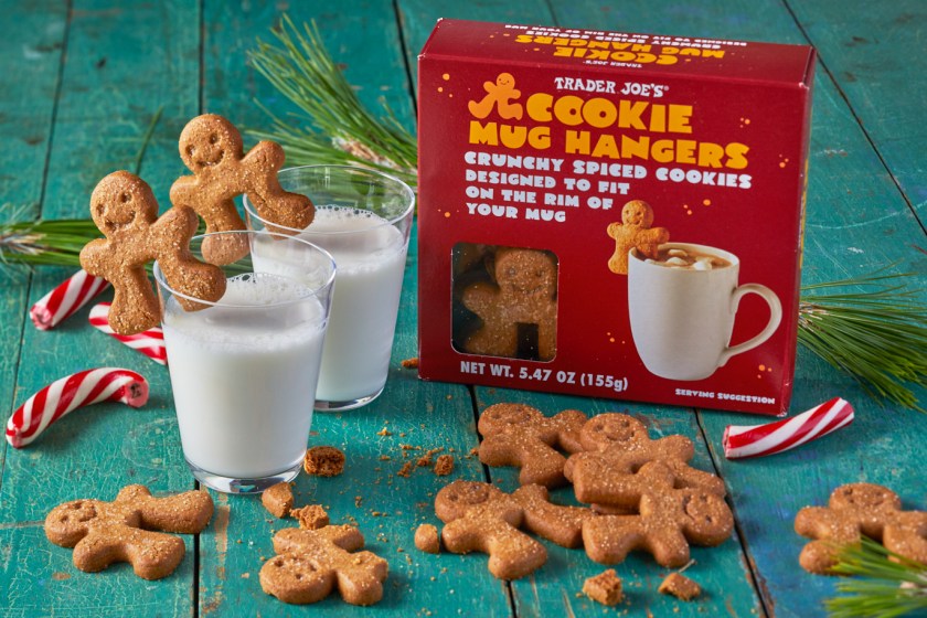 Trader Joe's Cookie Mug Hangers perched on a couple glasses of milk, more cookies broken on surface