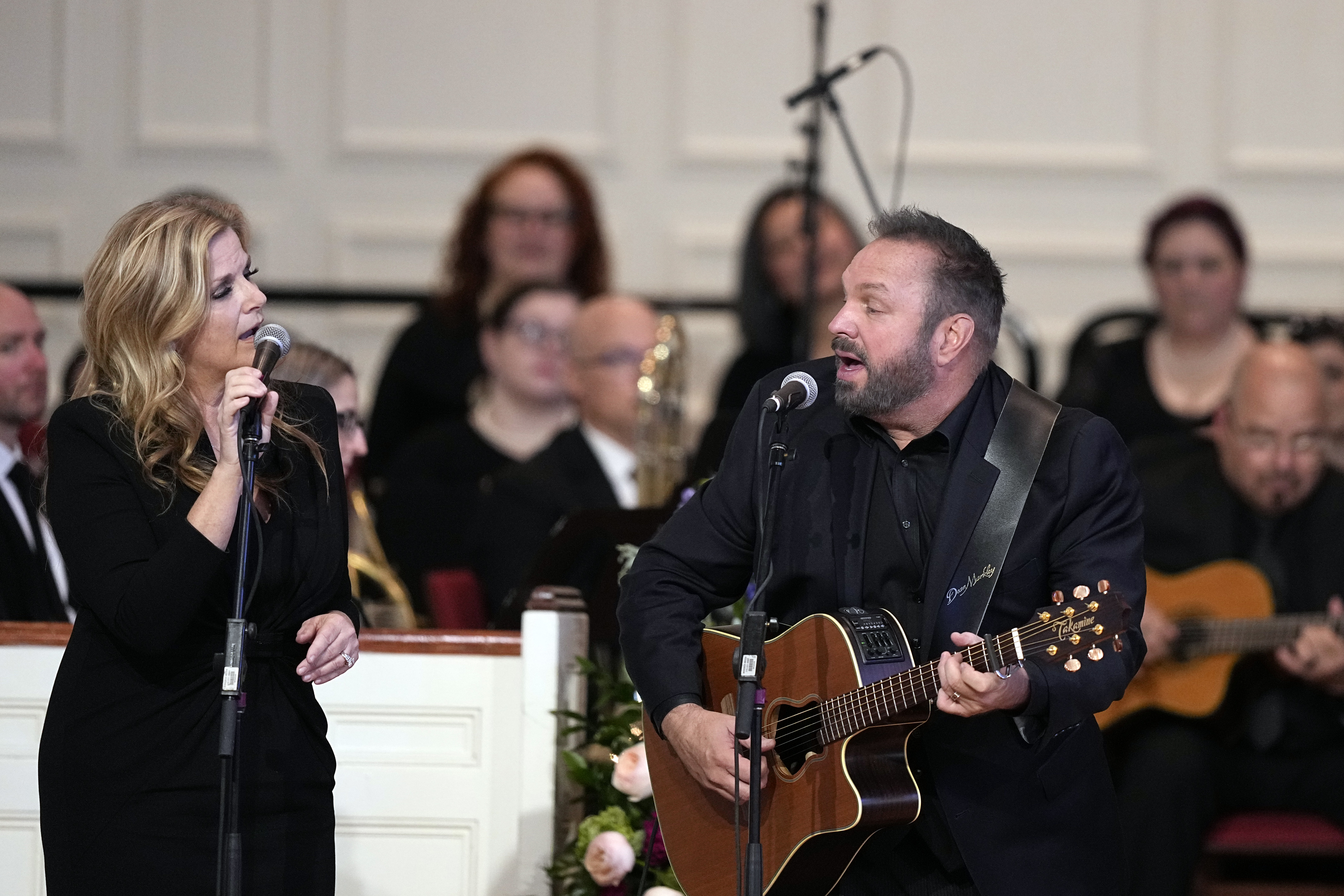 ATLANTA, GEORGIA - NOVEMBER 28: Trisha Yearwood and Garth Brooks perform "Imagine" at a tribute service for former first lady Rosalynn Carter at Glenn Memorial United Methodist Church at Emory University on November 28, 2023 in Atlanta, Georgia. Rosalynn Carter, who passed away on November 19 at the age of 96, was married to former U.S. President Jimmy Carter for 77 years. In her lifetime she was an activist and writer known to be an advocate for the elderly, affordable housing, mental health, and the protection of monarch butterflies. President Joe Biden, former President Jimmy Carter and every living first lady are attending the service.