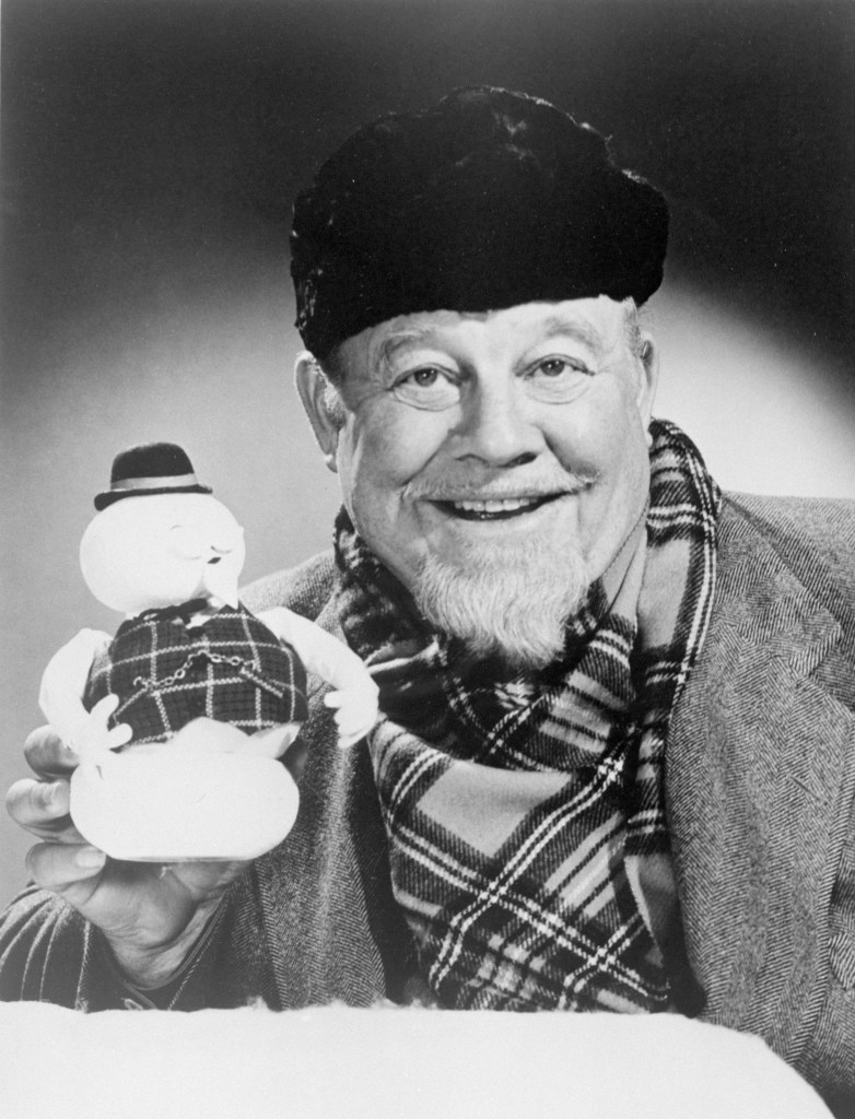 Burl Ives holds up the stop-motion snowman puppet of Sam, whose voice he provides in the TV Christmas special, "Rudolph the Red-Nosed Reindeer".
