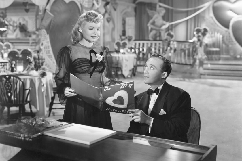 Linda Mason (Marjorie Reynolds) joins Jim Hardy (Bing Crosby) at the piano to look at a Valentine in his nightclub the Holiday Inn in the 1942 musical Holiday Inn. 