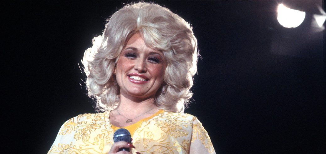 LOS ANGELES - CIRCA 1975: Country singer Dolly Parton performs onstage wearing a yellow dress, circa 1975, Los Angeles, California.