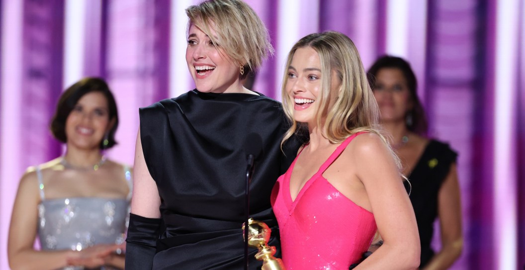 Greta Gerwig and Margot Robbie accept the award for Cinematic and Box Office Achievement for "Barbie" at the 81st Golden Globe Awards