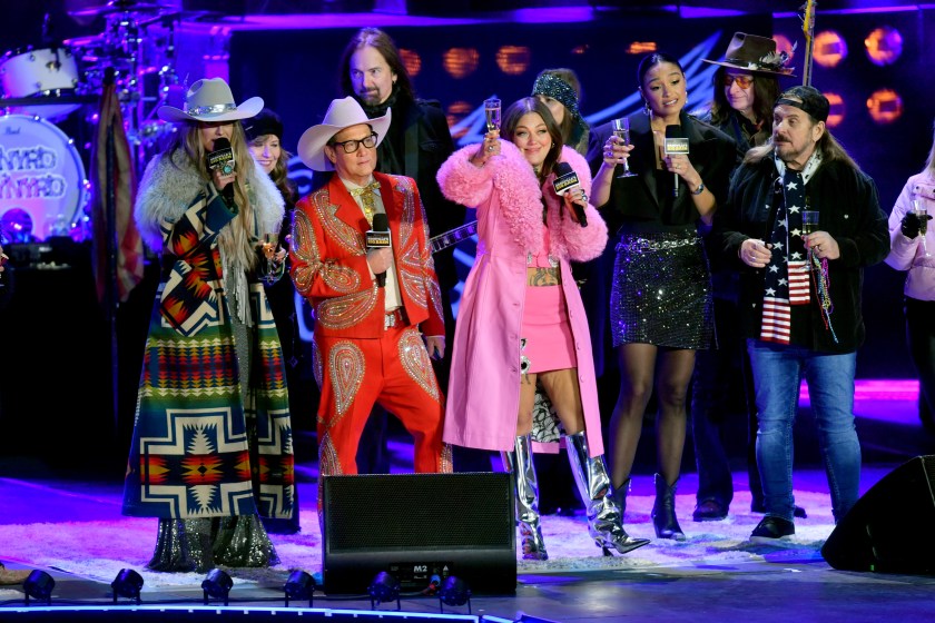 NASHVILLE, TENNESSEE - DECEMBER 31: (L-R) Lainey Wilson, Rob Schneider, Elle King, Rachel Smith and Johnny Van Zant of Lynyrd Skynyrd speak onstage for New Year's Eve Live: Nashville's Big Bash at Bicentennial Capitol Mall State Park on December 31, 2023 in Nashville, Tennessee.