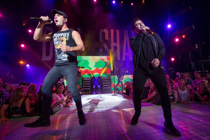 CLARKSTON, MI - AUGUST 25: Dan Smyers (L) and Shay Mooney of country music duo Dan + Shay perform in support of the Good For a Good Time Tour 2016 at DTE Energy Music Theater on August 25, 2016 in Clarkston, Michigan.