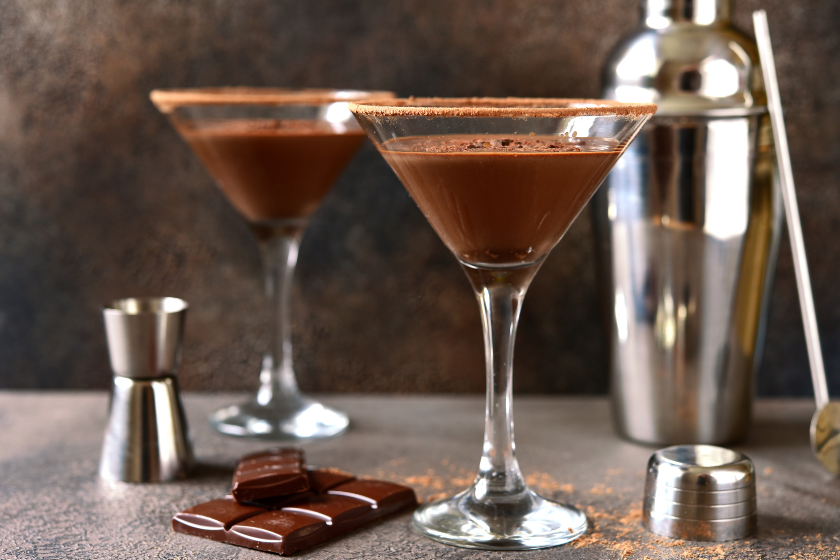 Delicious chocolate martini in a glasses on a dark slate, stone or concrete background.