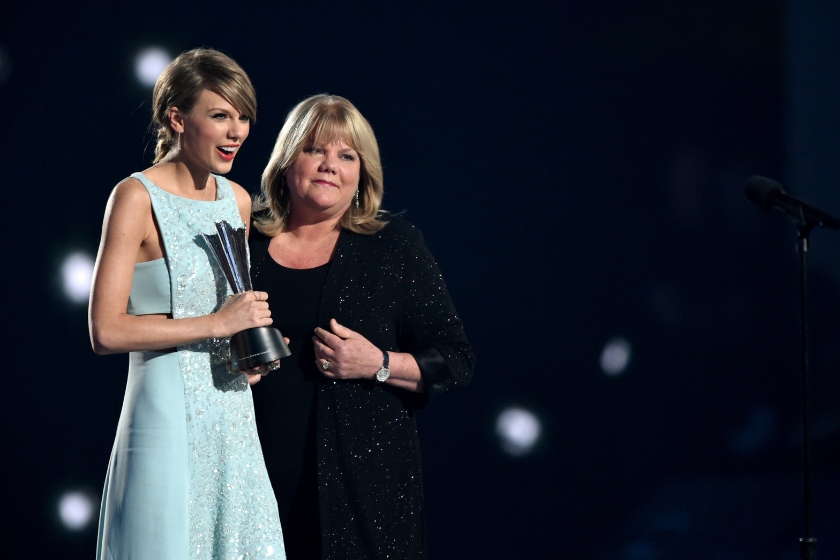 Taylor Swift accepts the Milestone Award from Andrea Swift onstage at the 50th Academy Of Country Music Awards in 2015.