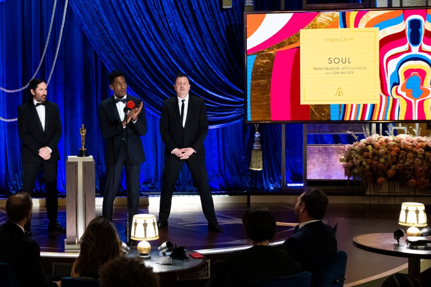 LOS ANGELES, CALIFORNIA - APRIL 25: (EDITORIAL USE ONLY) In this handout photo provided by A.M.P.A.S., (L-R) Trent Reznor, Jon Batiste, and Atticus Ross accept the Music (Original Score) award for 'Soul' onstage during the 93rd Annual Academy Awards at Union Station on April 25, 2021 in Los Angeles, California. 
