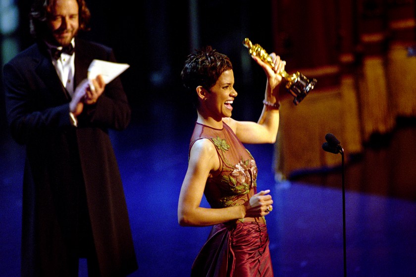American actress Halle Berry accepts the Academy Award for Best Actress for her performance in "Monster's Ball", at the 74th Annual Academy Awards, held at the Kodak Theater In Hollywood, California, March 24, 2002. Applauding her (left) is Australian actor Russell Crowe.