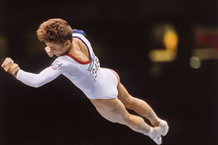 ATLANTA - JULY 23: Kerri Strug of the United States performs a vault during the team competition of the Women's Gymnastics event of the 1996 Summer Olympic Games held on July 23, 1996 in the Georgia Dome in Atlanta, Georgia. Strug was part of the gold medal winning USA Women's team, nicknamed the Magnificent Seven. 