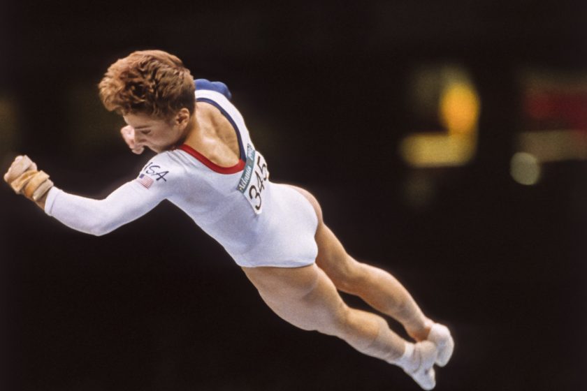ATLANTA - JULY 23: Kerri Strug of the United States performs a vault during the team competition of the Women's Gymnastics event of the 1996 Summer Olympic Games held on July 23, 1996 in the Georgia Dome in Atlanta, Georgia. Strug was part of the gold medal winning USA Women's team, nicknamed the Magnificent Seven.