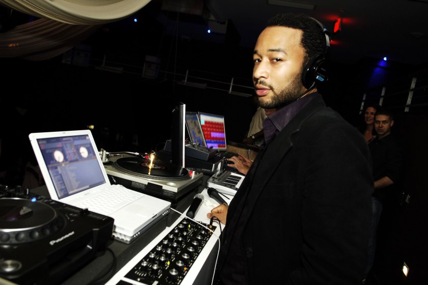 MIAMI BEACH , FL - NOVEMBER 28 : Singer John Legend works the DJ booth at his after party at The Fifth nightclub on November 28, 2006 in Miami Beach , Florida. 