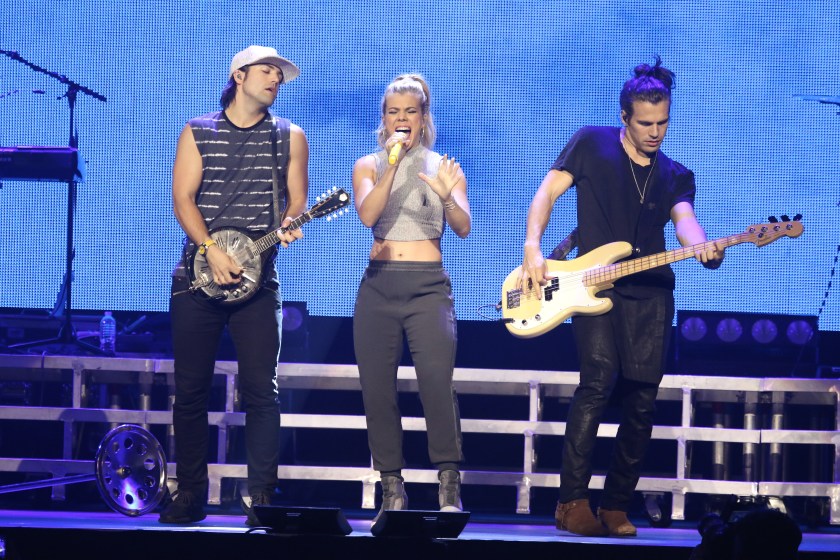 The Band Perry are shown performing on stage during a live concert appearance on September 25, 2015.