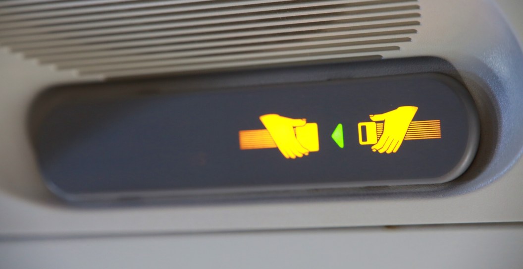 passenger starts plane delay after refusing to use seatbelt