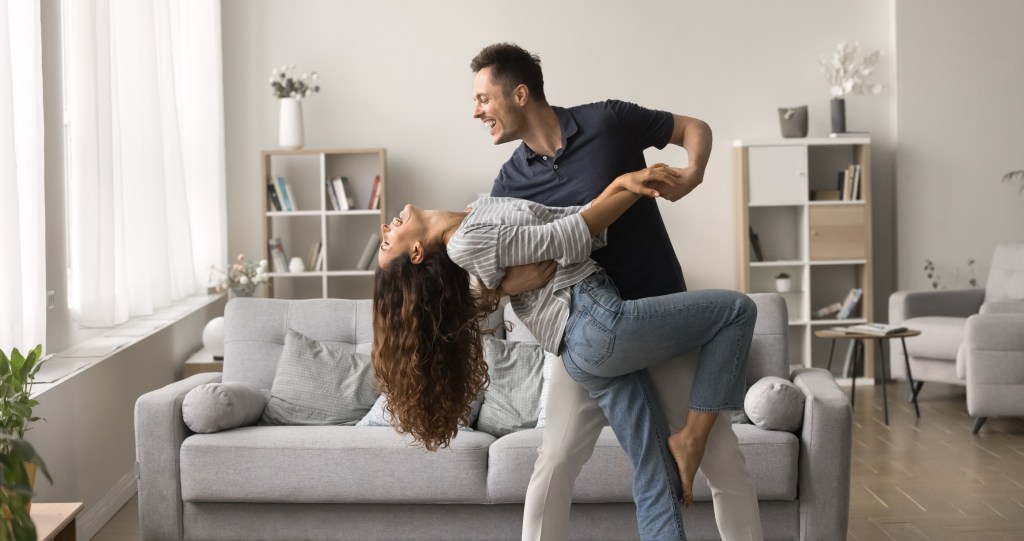 couple dancing together in their living room