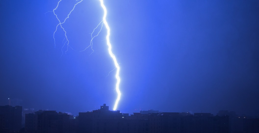 Lightning forks across the sky during a thunderstorm over Doha on March 23, 2026. (Photo by Mahmud Hams / AFP via Getty Images)