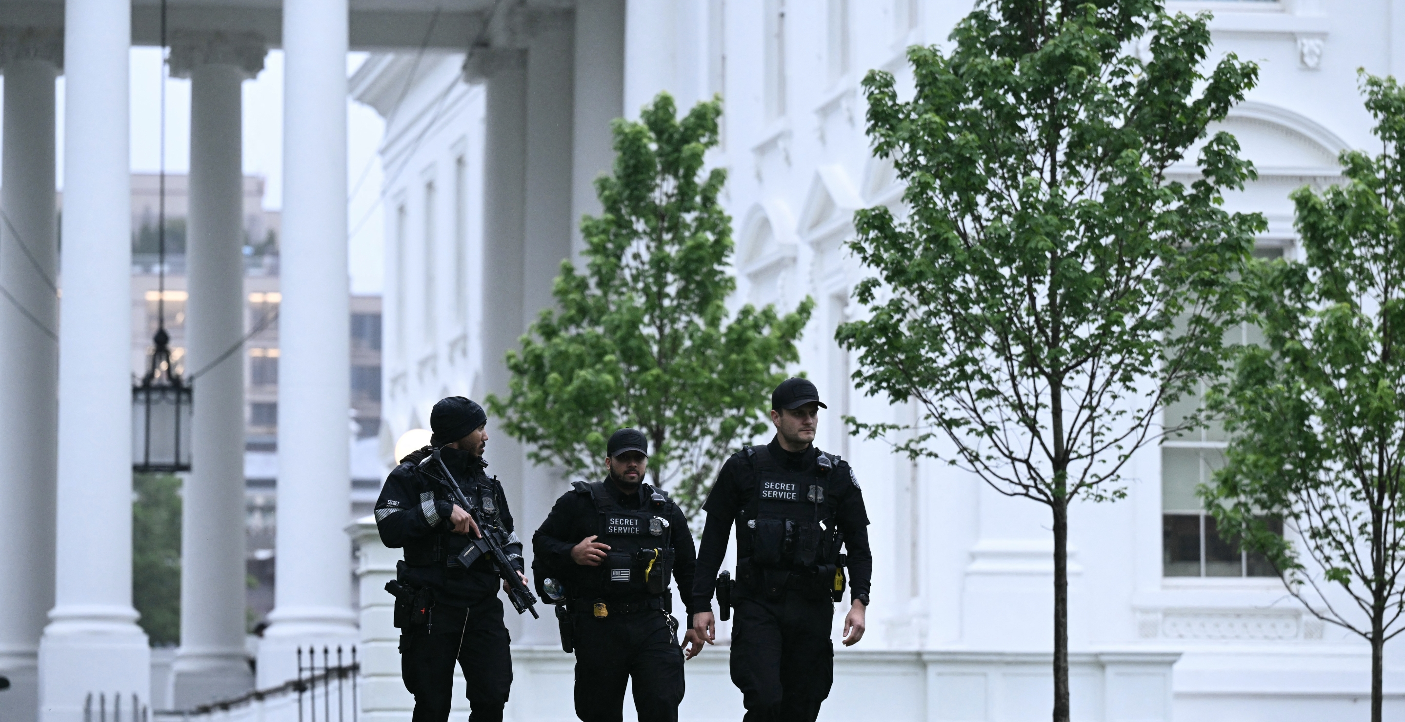 Secret Service agents are seen after a lockdown was lifted at the White House in Washington, DC, on May 23, 2026. Police and security forces swarmed the area around the White House on the evening of May 23 after reports of shots fired