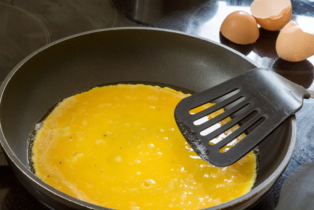 liquid egg in the pan for pancakes or scrambled eggs