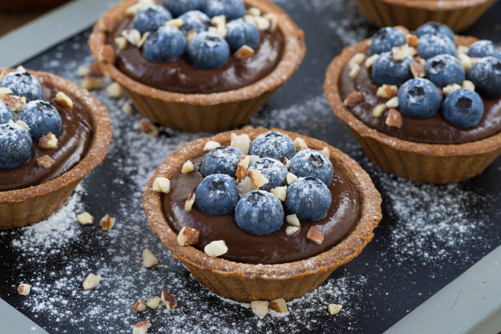 chocolate mousse with fresh blueberries and nuts in tartlets