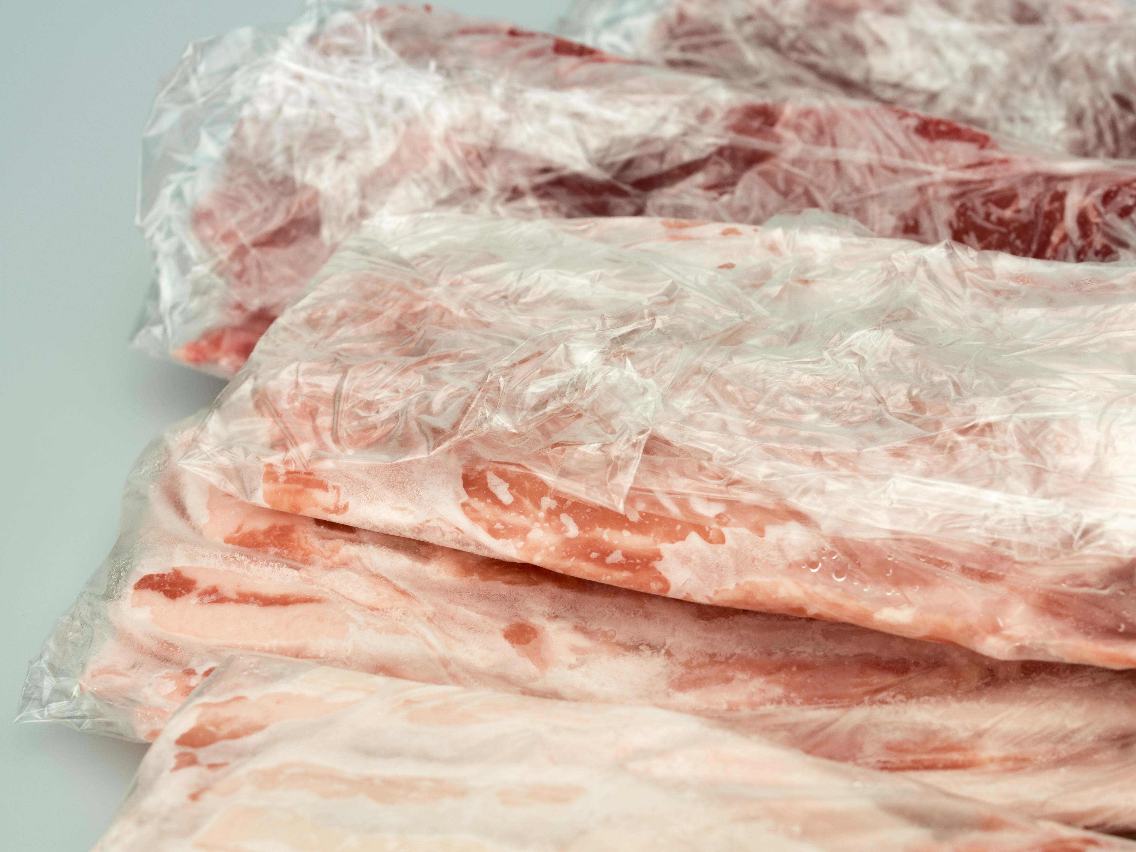 frozen meat in plastic package isolated on white background