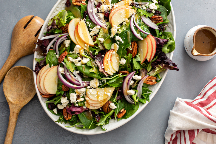 Winter salad with apple, red onion and pecans with vinaigrette dressing