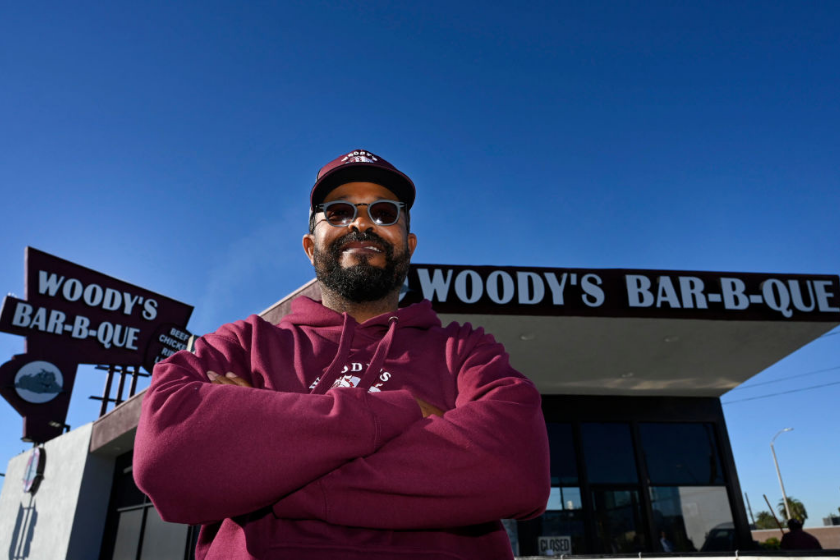 Roderick Phillips, owner of Woody's Bar-B-Que in Inglewood, stands outside his restaurant.