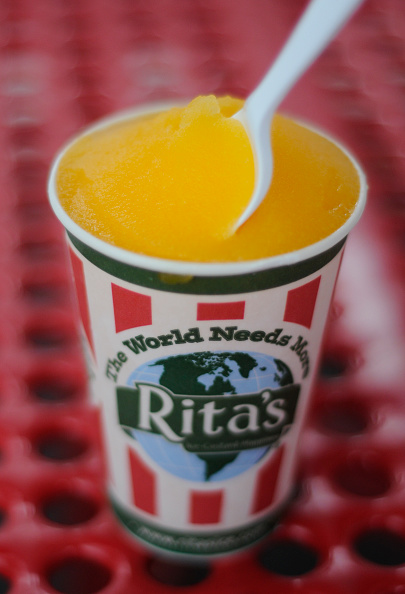A Rita's cup with the slogan "The World Needs More Rita's.