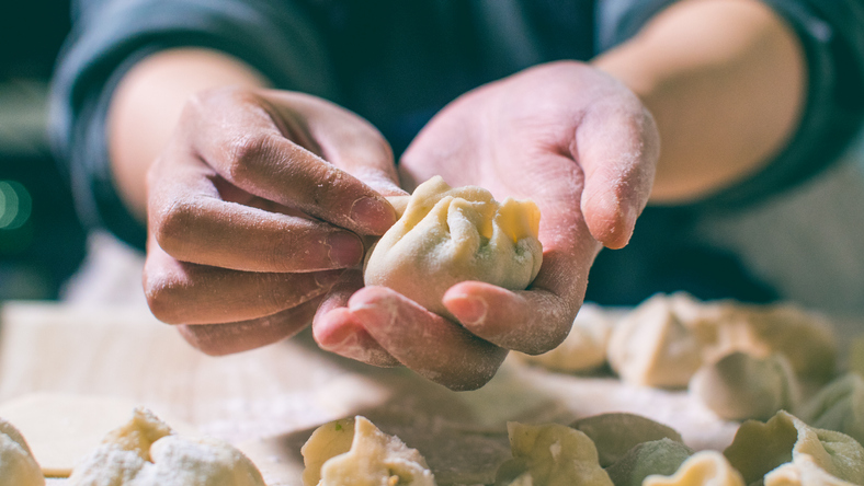 hands making dumplings