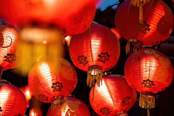 Rows of colorful glowing red Chinese lanterns