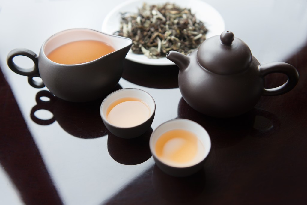 Tea Set and White Tea Leaves