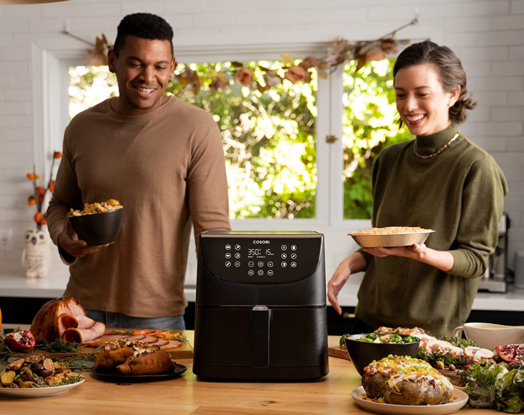man and woman using air fryer
