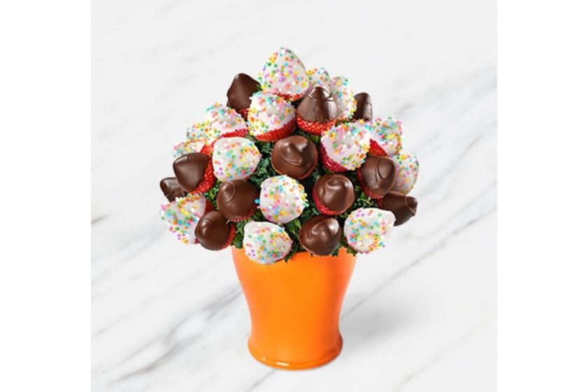 strawberries bouquet from Edible Arrangements (white chocolate dipped strawberries in an orange vase) 