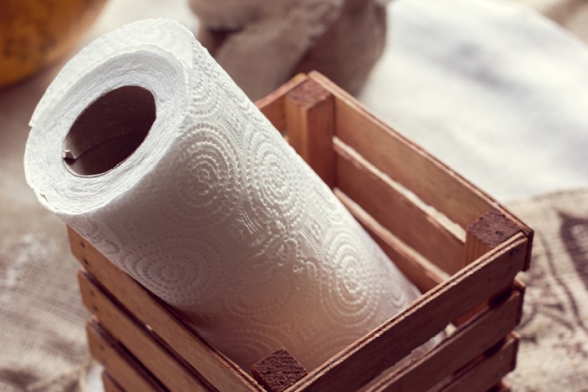 a roll of paper towels in a wooden box
