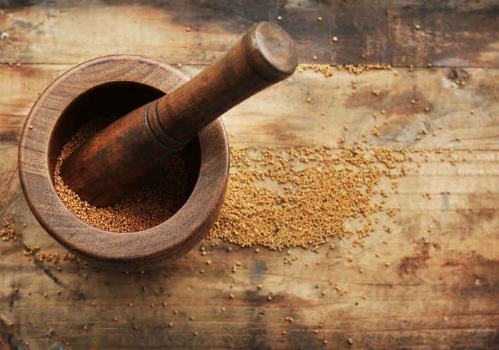 Mortar and pestle with mustard seeds