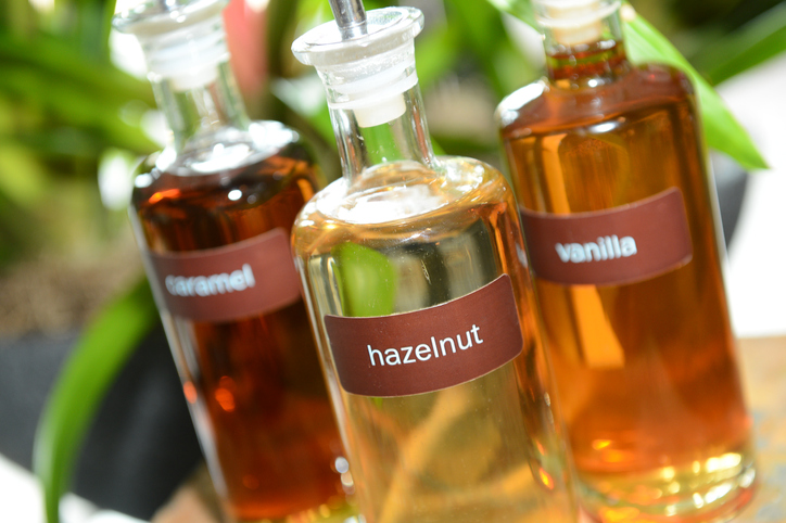  hazelnut, vanilla and caramel coffee syrups for flavoring a drink.