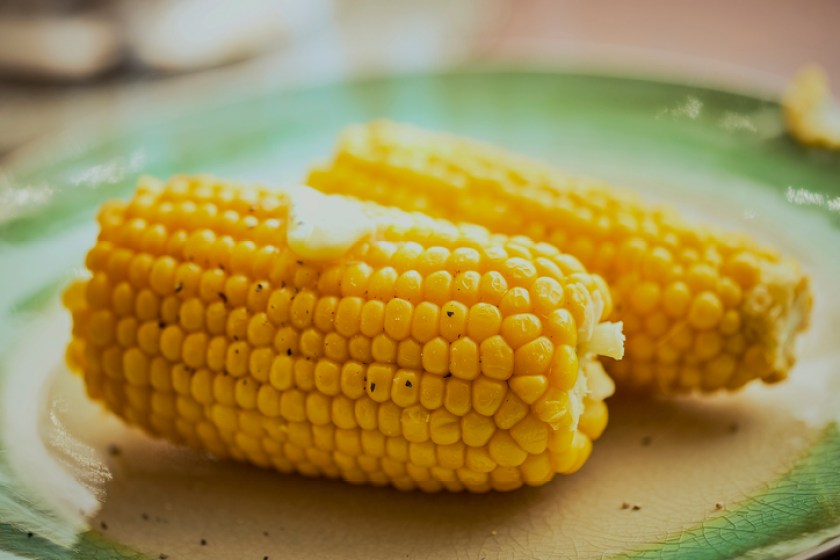 Two sweetcorn corn on the cob cooked with butter