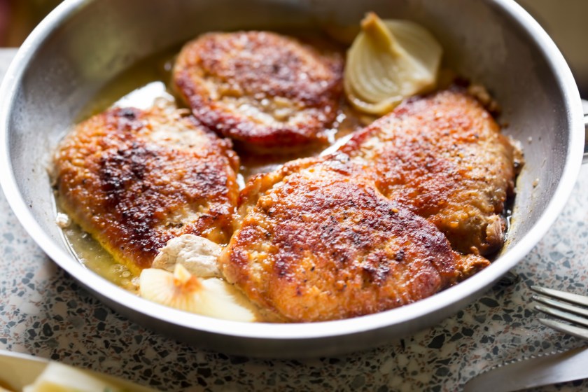 Breaded pork chops with fried with onion