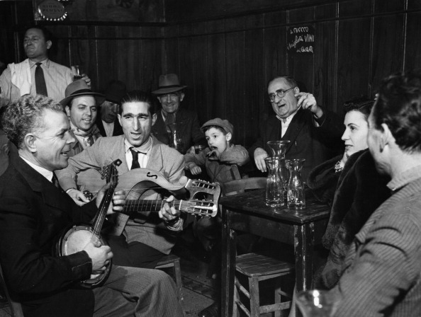 People Playing And Singing In A Tavern